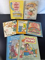 All seven books front covers visible