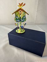 Front view of enamel birdhouse box on presentation box