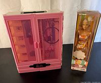 Closet closed beside boxed Summer Garden Barbie doll