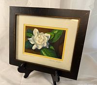 Full view of framed artwork on stand