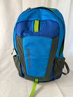 Front view of backpack showing overall design, colors, pockets and logo
