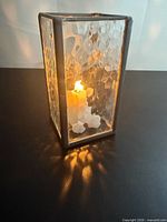 Lit view showing hammered glass texture and frame