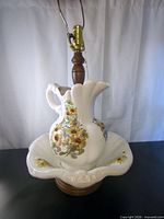 Full view of ceramic pitcher and basin lamp showing floral design and hardware