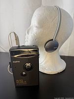 Front view of Sanyo cassette player connected to Sony headset on display head