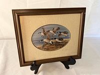 Full view of framed, matted print on easel