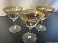 Three glasses standing upright displaying overall form