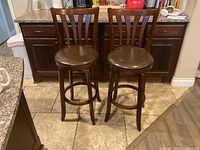 pair of wooden bar stools front view