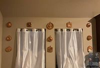 Wall display showing all eleven copper molds in various shapes