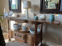 Full view of Ethan Allen wooden service cart with accessories on top and shelf