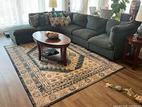Full view of grey modular sectional arranged in L shape with coffee table in front
