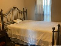 Full view of queen wrought iron bed with headboard and frame assembled