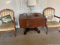 Front view showing table with both leaves down between two chairs