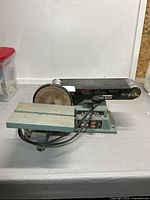 Overall view of Delta combination sander showing belt housing, disc, and table