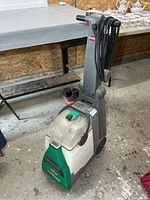 Full view of Bissell Big Green carpet cleaner showing handle, cord and tanks