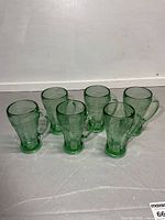 All six green Coca-Cola glass mugs front view