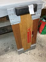 Front view showing Motomaster logo, wood slats, steel corner plates