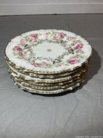 stack of six floral dessert plates side view
