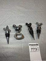 Full set: three Mickey head stoppers and matching opener