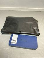 Closed black pouch and blue Staedtler case