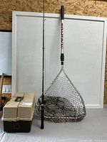 Net, rod with reel, closed tackle box overview