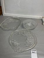 Overview of three glass serving pieces: oval tray, cut glass bowl, round cake plate