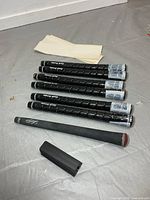 Six wrapped Golf Pride grips, extra grip, clamp, tape strips