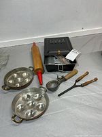 All items grouped: rolling pin, two copper egg pans, scoop, curling iron, boxed popcorn maker