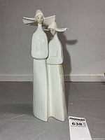 Front view of porcelain figurine showing full height and design
