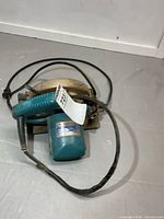 Overall saw with taped cord and plug visible