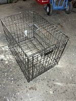Full view of metal wire pet kennel showing overall condition