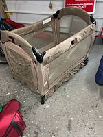 Overall view of beige check Eddie Bauer play yard