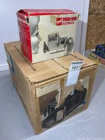 Both boxed items: Bell & Howell projector box and GAF Pana-Vue Automatic box