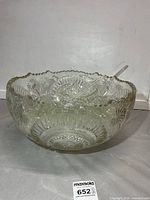 overall view of large pressed glass punch bowl with ladle inside