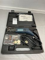 Rotary tool in case with accessory box and manual visible