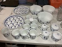 Full lot layout showing mugs, bowls, platters, cream and sugar sets