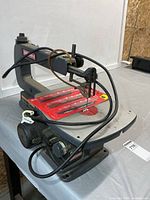 Left front view of Craftsman 16" scroll saw with blade package on table