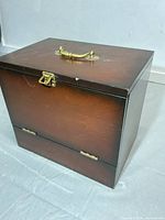 Closed wooden shoe shine box showing exterior finish and brass handle