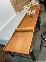 Full view of wooden tabletop shuffleboard on table with discs and boxed discs