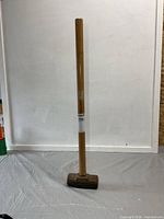 Full view of sledge hammer standing upright