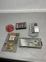 Overview of five tool accessory sets on table