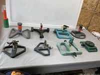 All eight sprinklers laid out on table