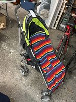 Front view of Summer Infant 3D Lite stroller with striped bunting bag draped over seat