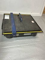 Top and side view showing full tile saw with fence