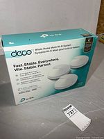 Front of boxed TP-Link Deco M5 system showing three-pack and key features