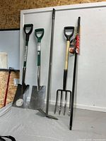 Full view of five yard tools standing upright