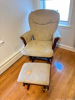 Front view of beige microfiber glider chair with ottoman