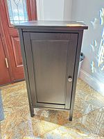 Front view of closed black cabinet