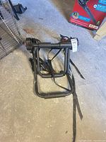 Overall view of folded bike rack showing frame and straps