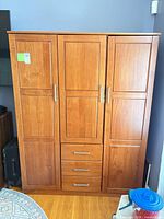 Front view showing closed three doors and three drawers