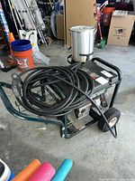 Full view of Craftsman gas pressure washer on wheels with hose coiled on top